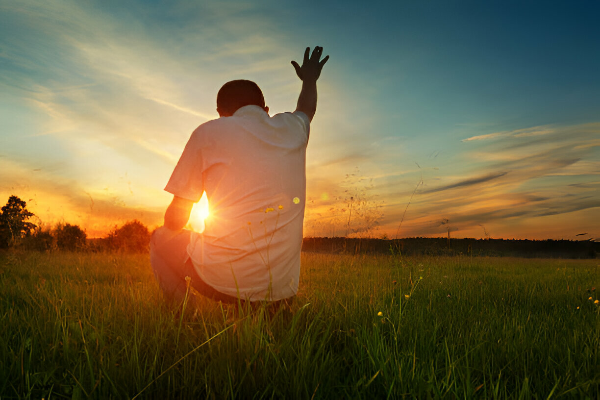A man raising his hands up in worship, emerging from the comfort zone